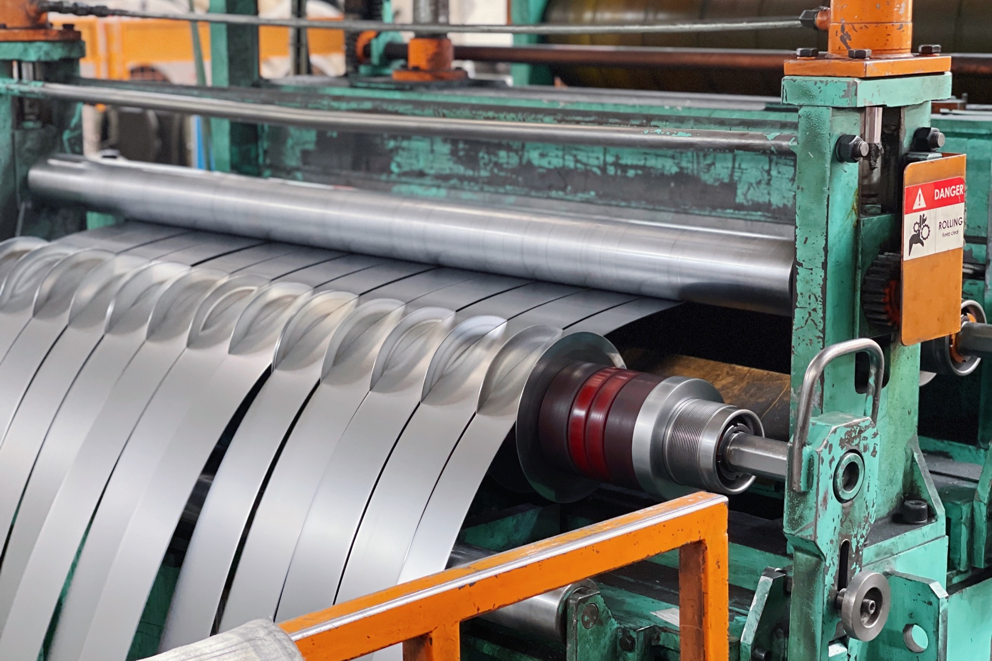 Steel coil passing through a precision slitting line